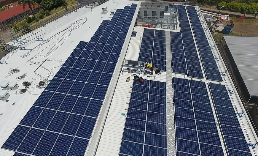 Solar panel installer working at Excelsior Public School.